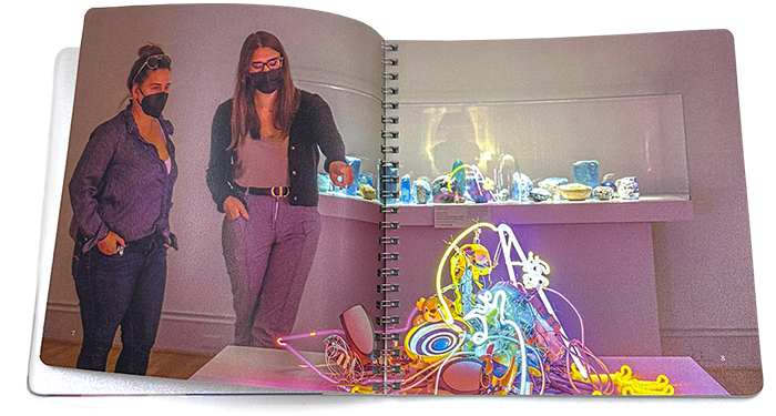 Open view of the New Glass Now museum catalog book showing interior spread.