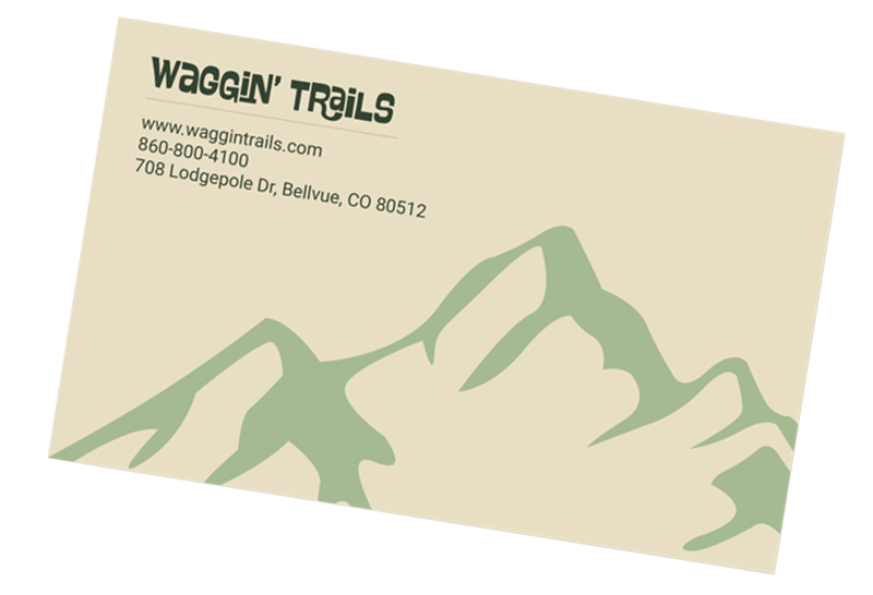 Back side of Waggin' Trails buisness card featuring text and mountain graphic